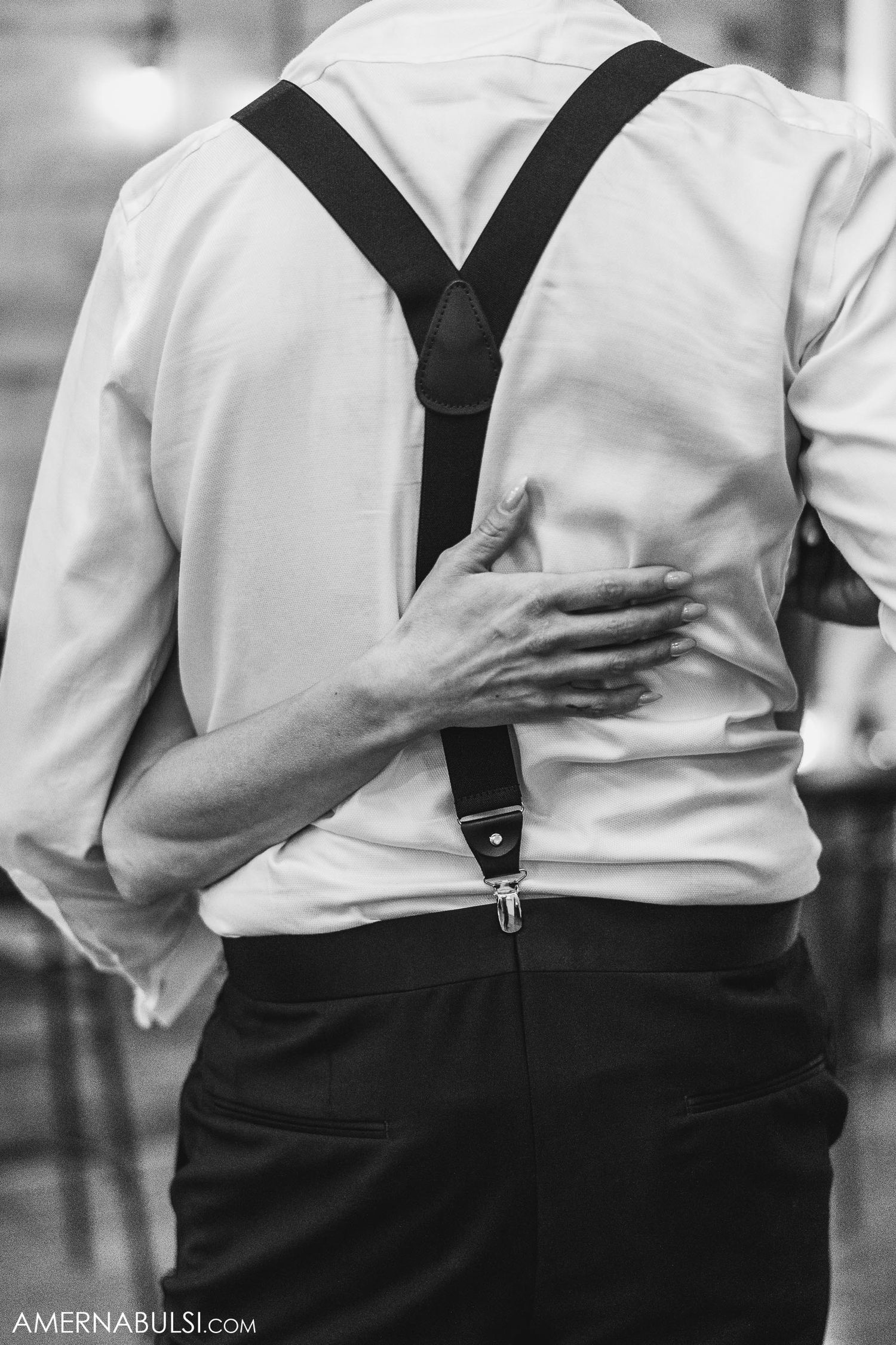 Black and white detail shot of suspenders on formal attire.