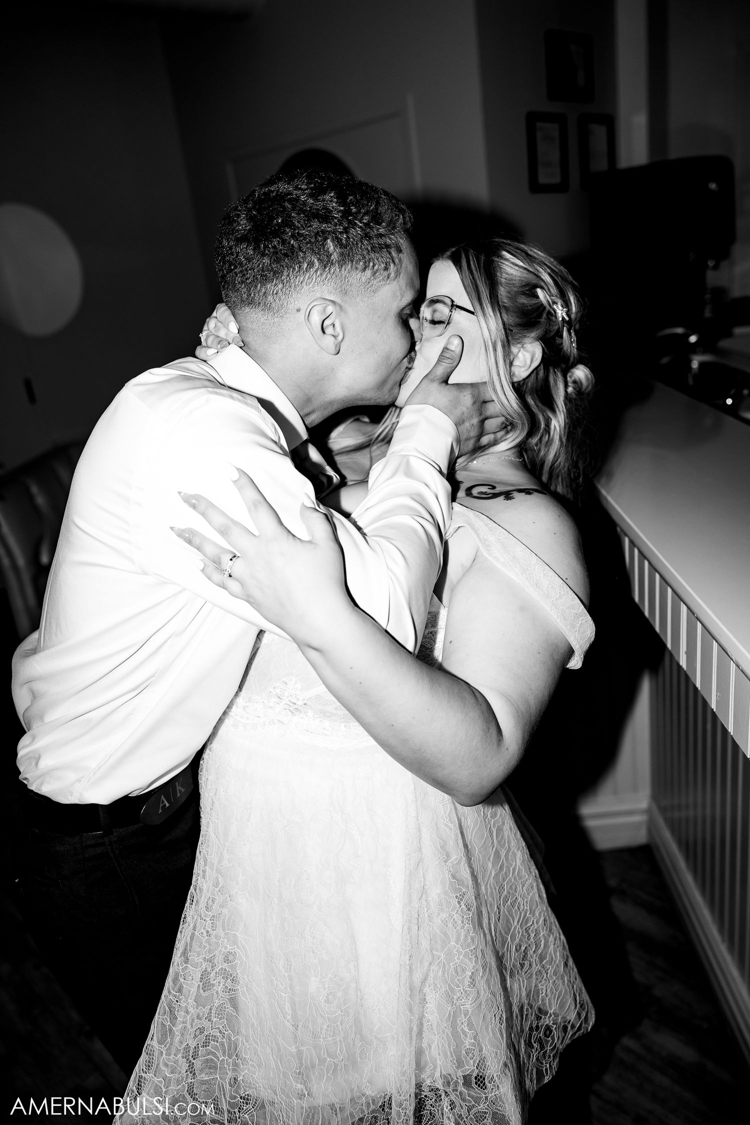 A black and white collage showing an emotional romantic embrace between a couple during what appears to be a wedding moment.