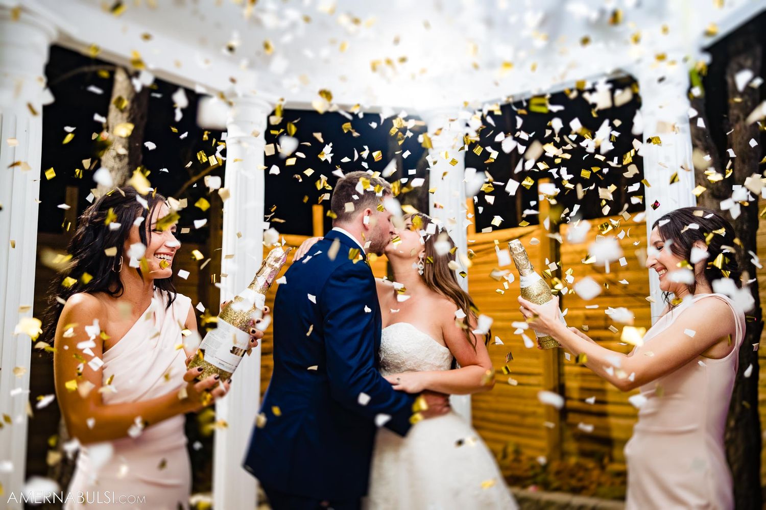 Wedding party showered with confetti during outdoor celebration.