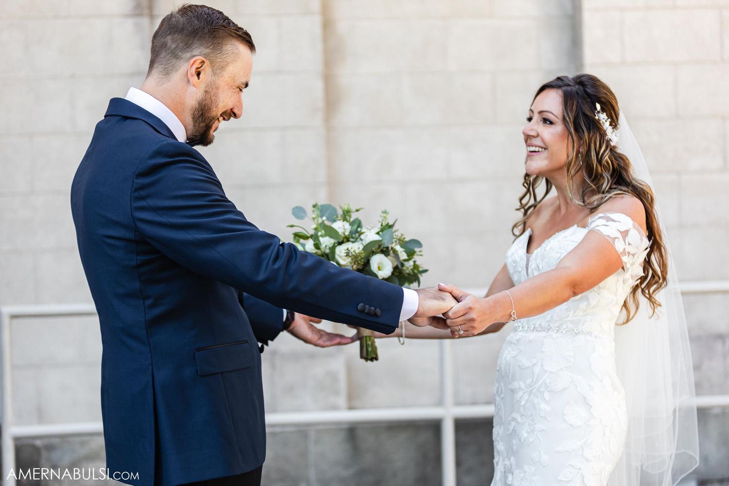 Joyful couple exchanges rings during outdoor wedding ceremony.