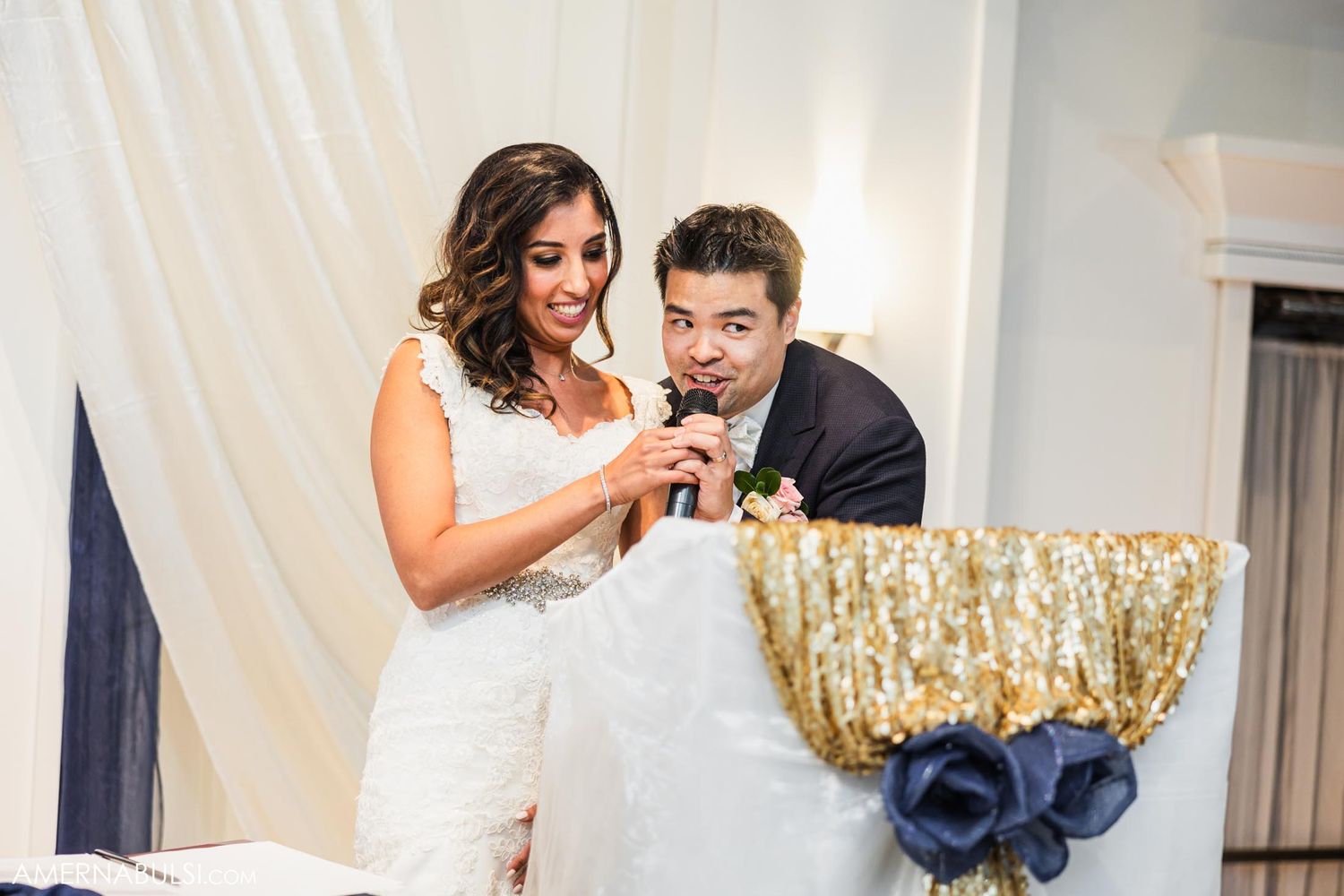 Couple sharing a dessert moment during their wedding reception.