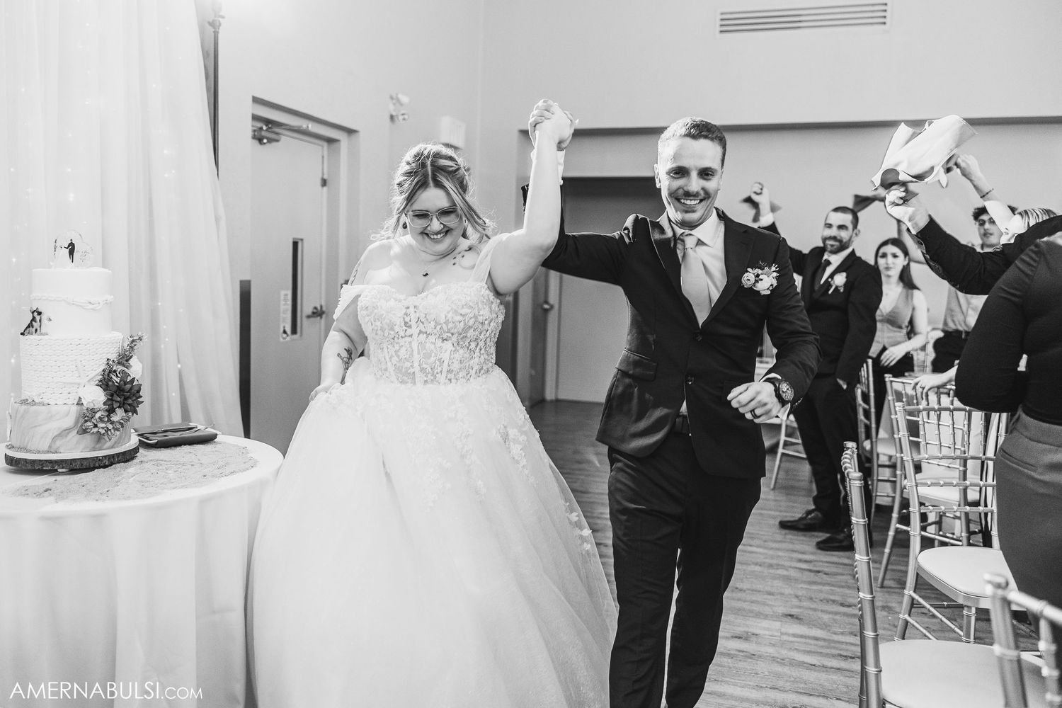 Newlyweds dancing together in an elegant ballroom during their wedding reception.