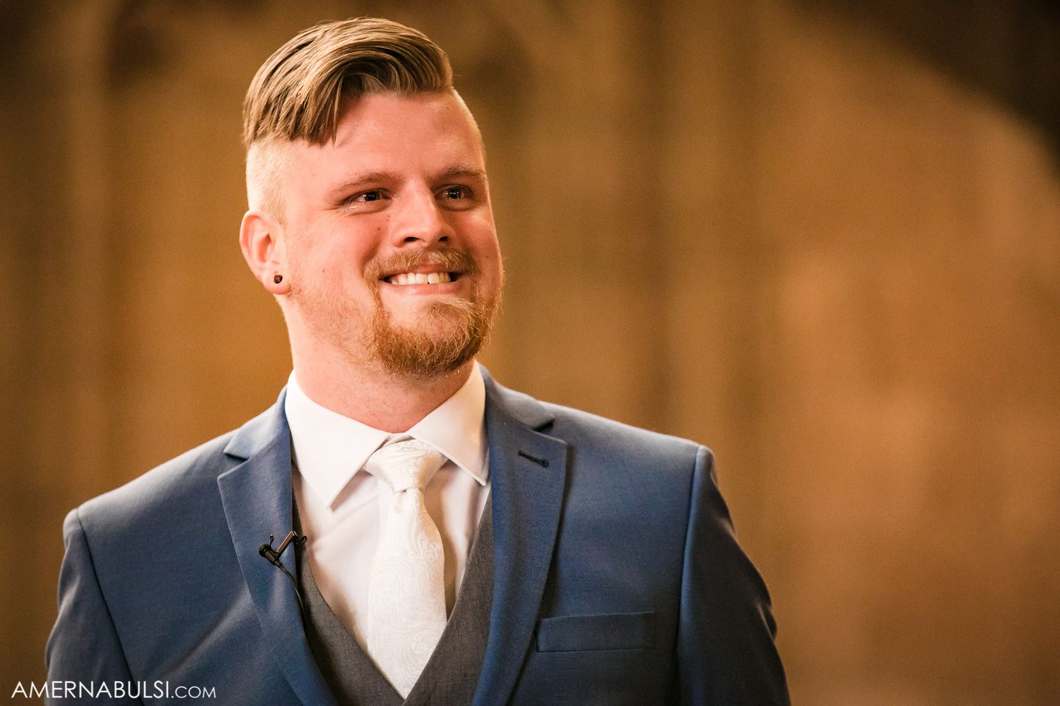 Groomsmen in navy suits standing together during wedding reception.