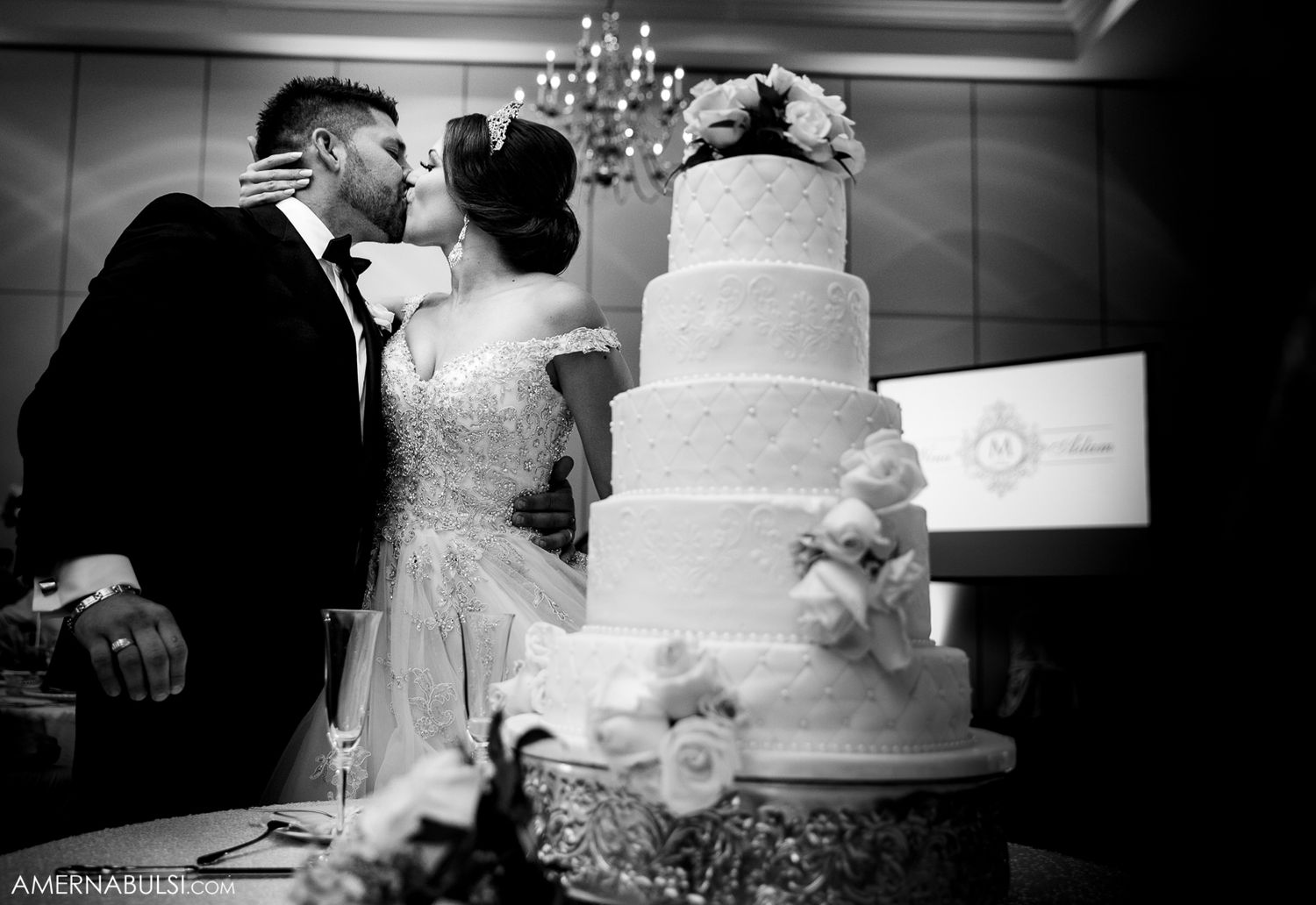 Black and white panoramic view of an elegant tiered wedding cake display.