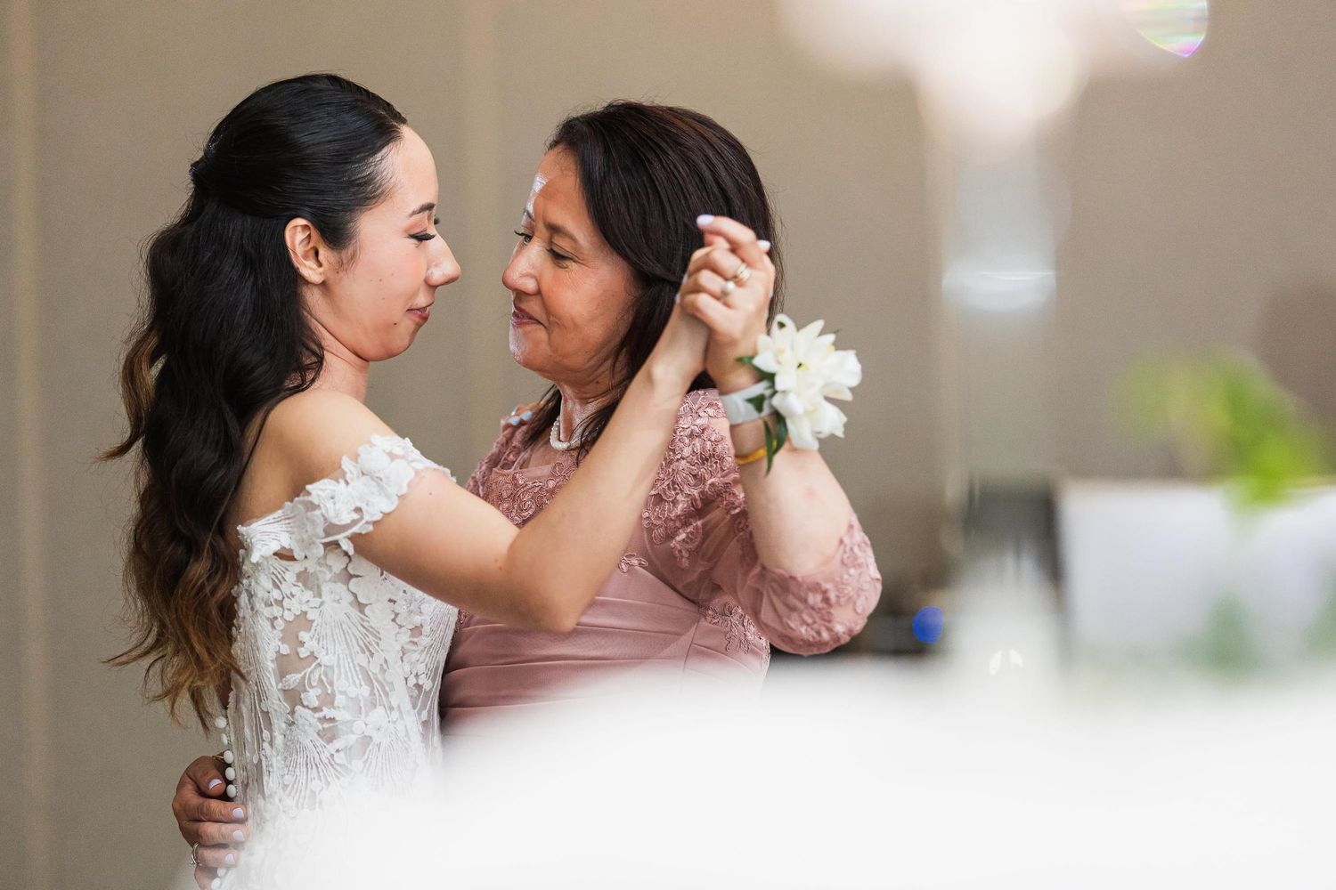 An emotional embrace shared between two people during a wedding celebration.