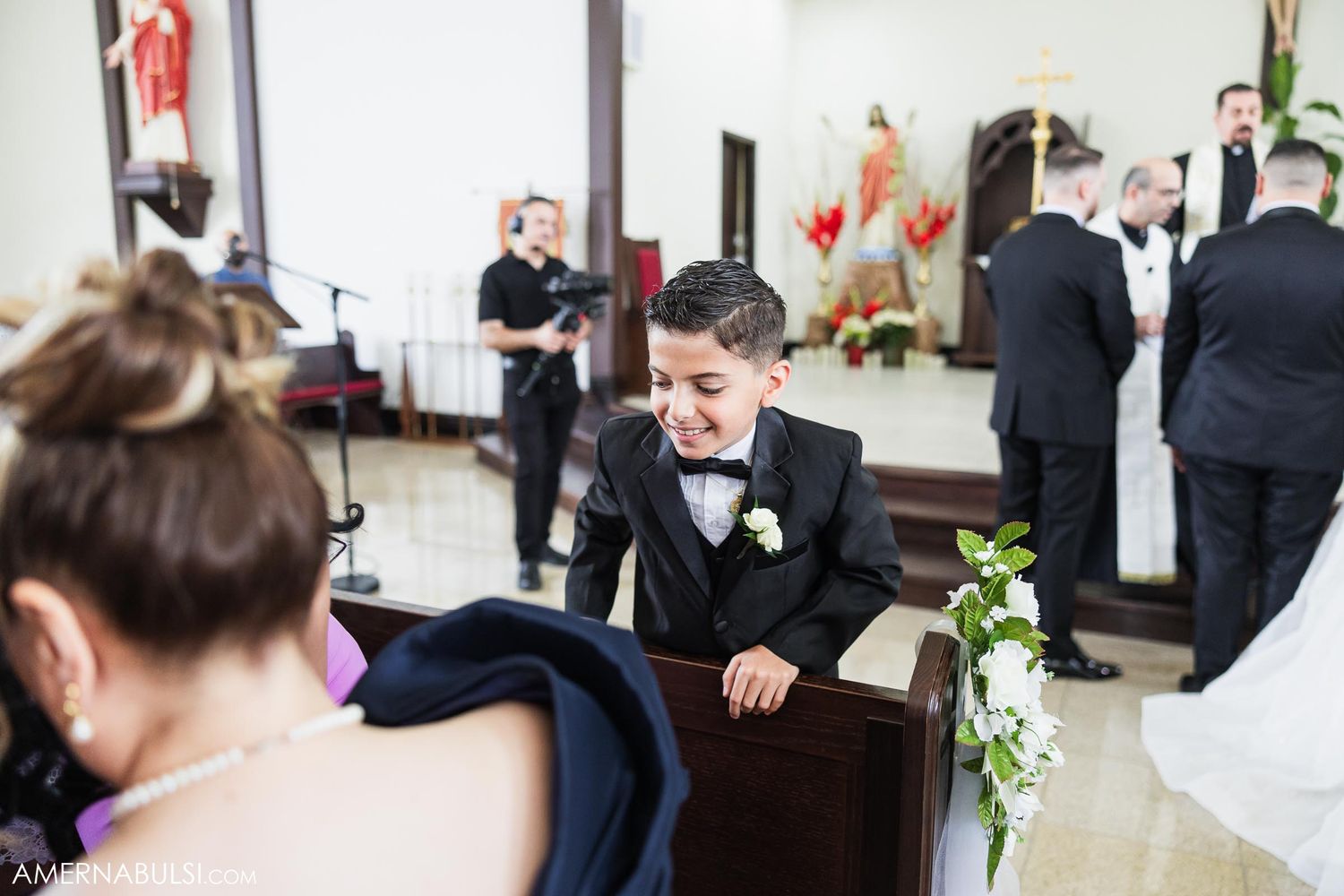 Candid pre-ceremony moment in church with wedding party members.