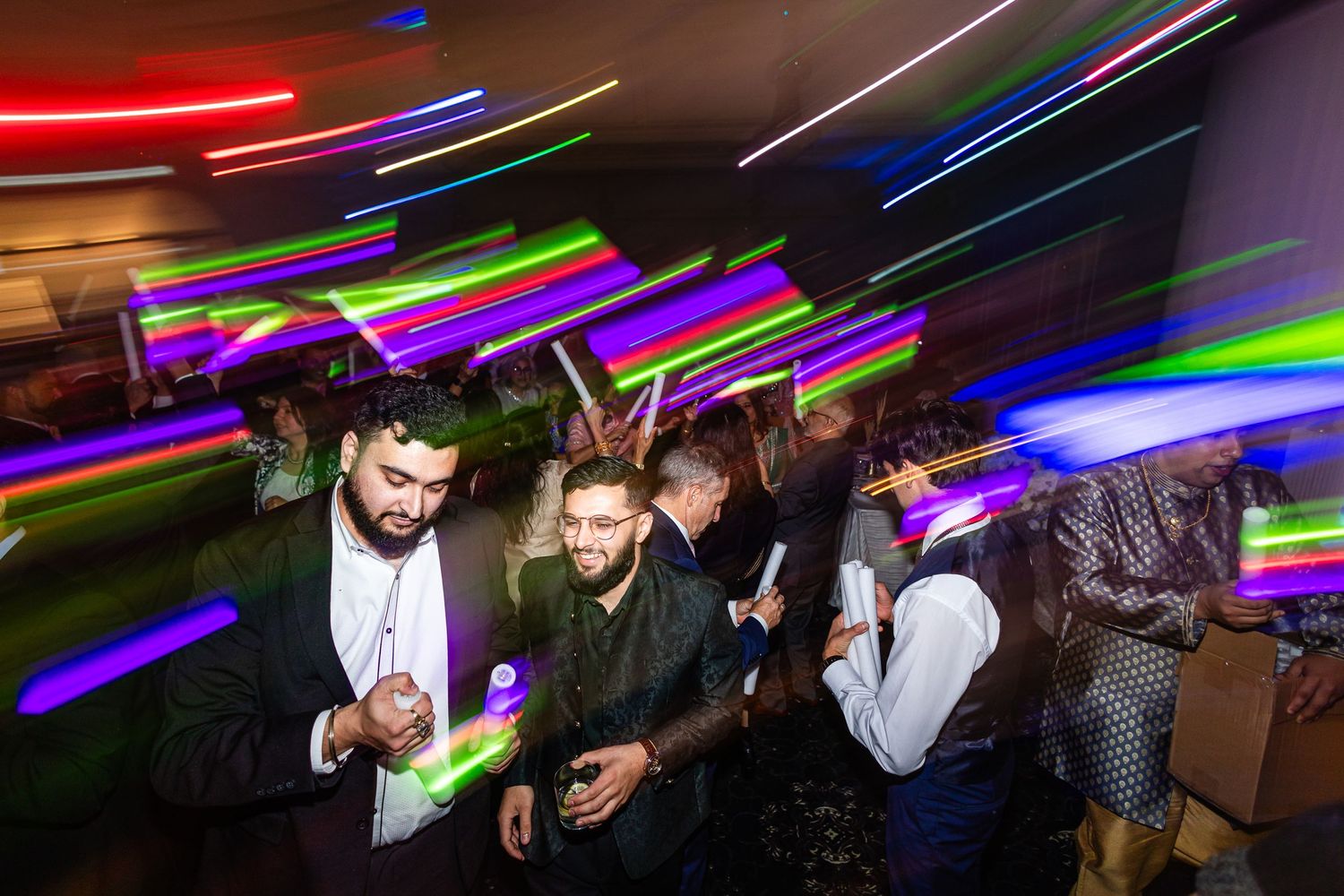Vibrant light trails and motion blur capture the energy of a dance party.