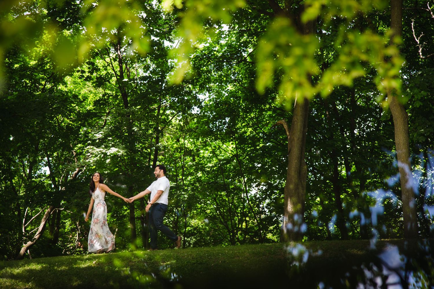 Romantic wedding portraits captured through lush green forest canopy.