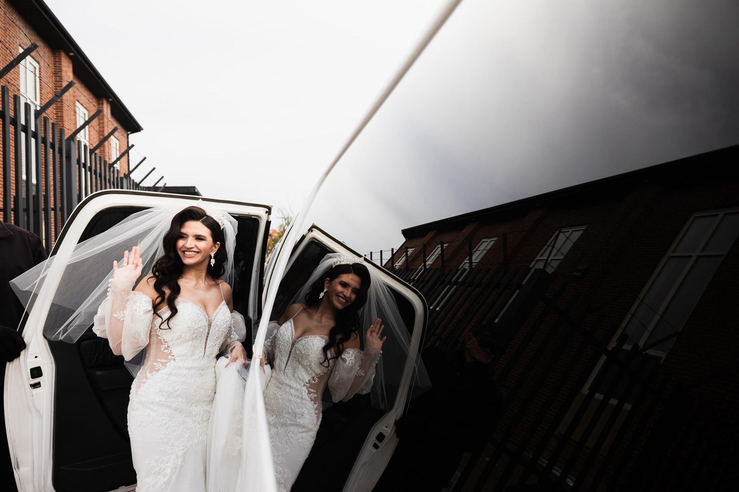 Wedding party members emerge from a white vehicle in elegant attire.