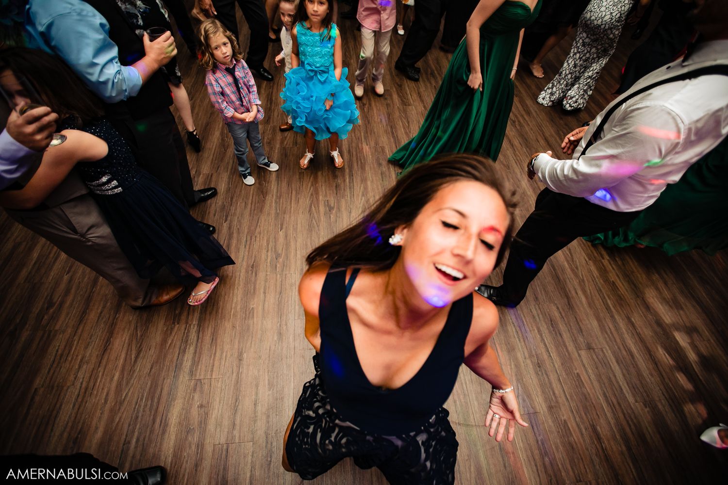 People dancing together on a wooden floor at a social dance event with a lively atmosphere.