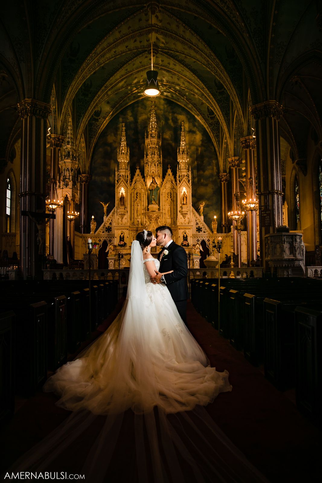 Dramatic wedding photos in a gothic cathedral with ornate architecture and stunning lighting.