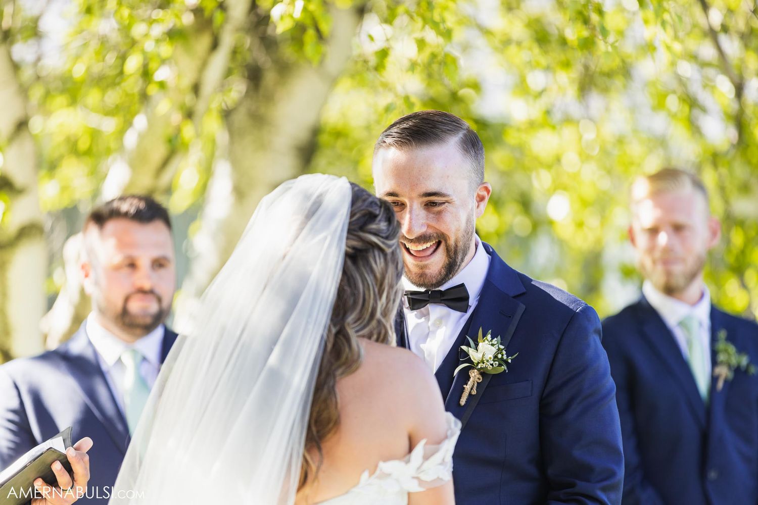 Joyful wedding ceremony moment outdoors with wedding party in formal attire.