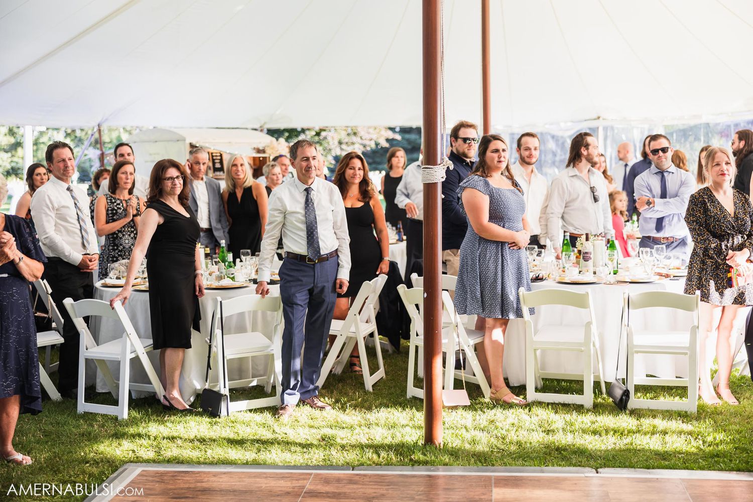 Romantic wedding dance moment captured through soft focus with guests watching in background.