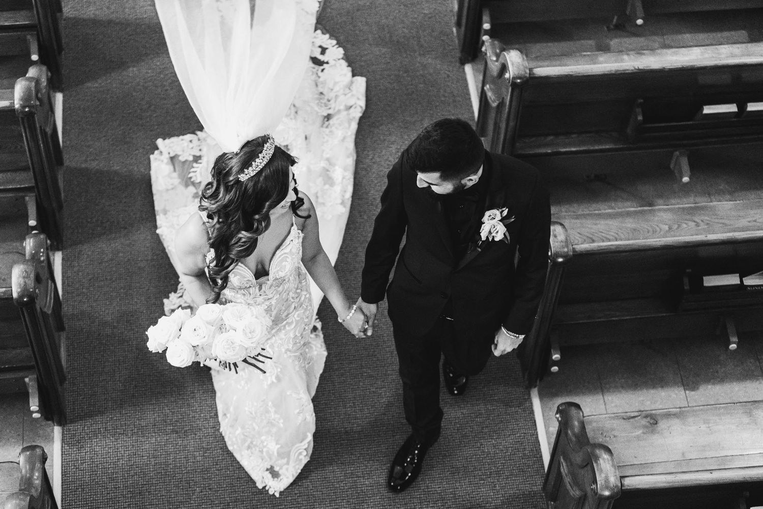 Vintage black and white photograph of wedding ceremony in traditional church setting.
