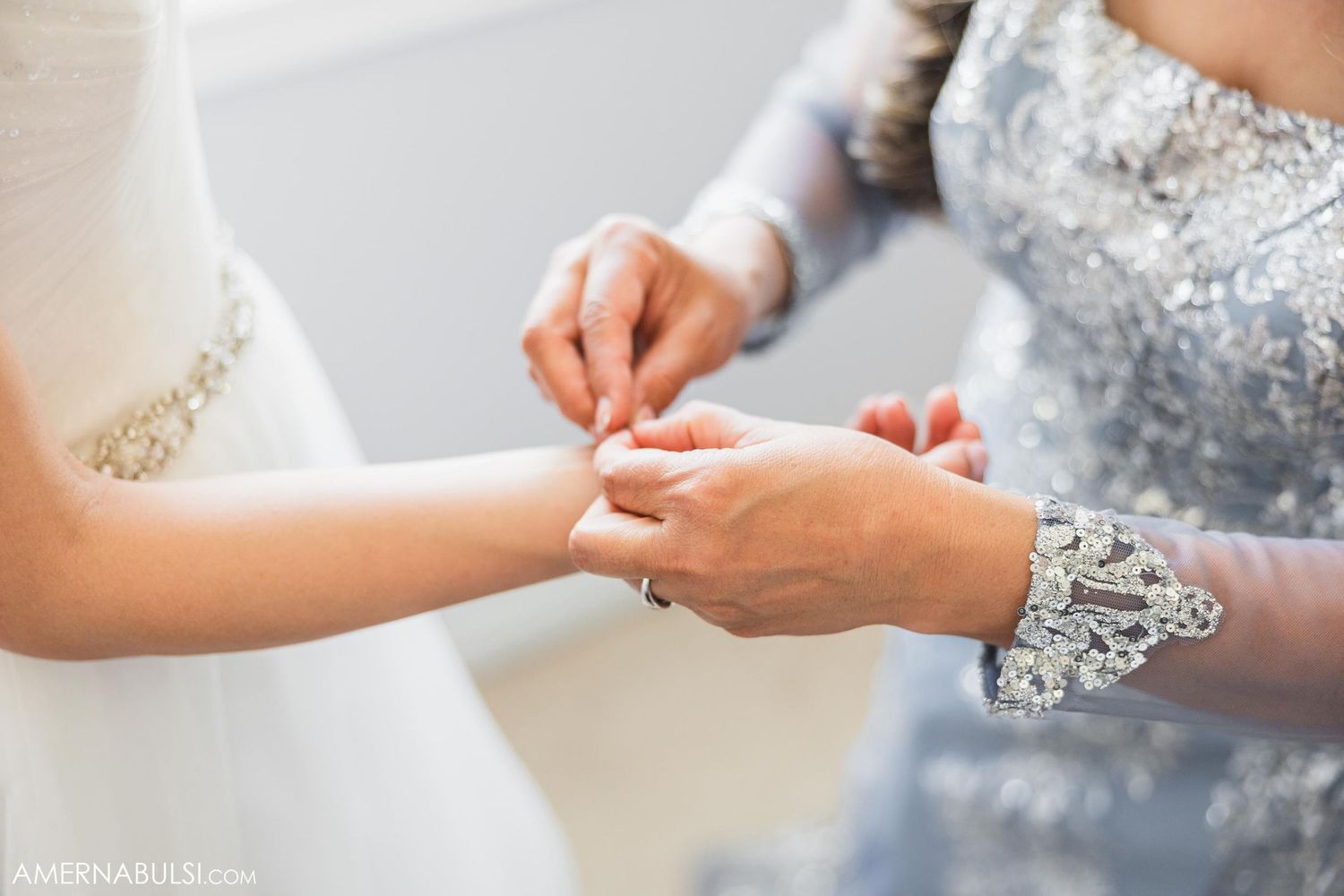 Close-up of hands during a wedding ceremony as one person places a ring on another's finger.