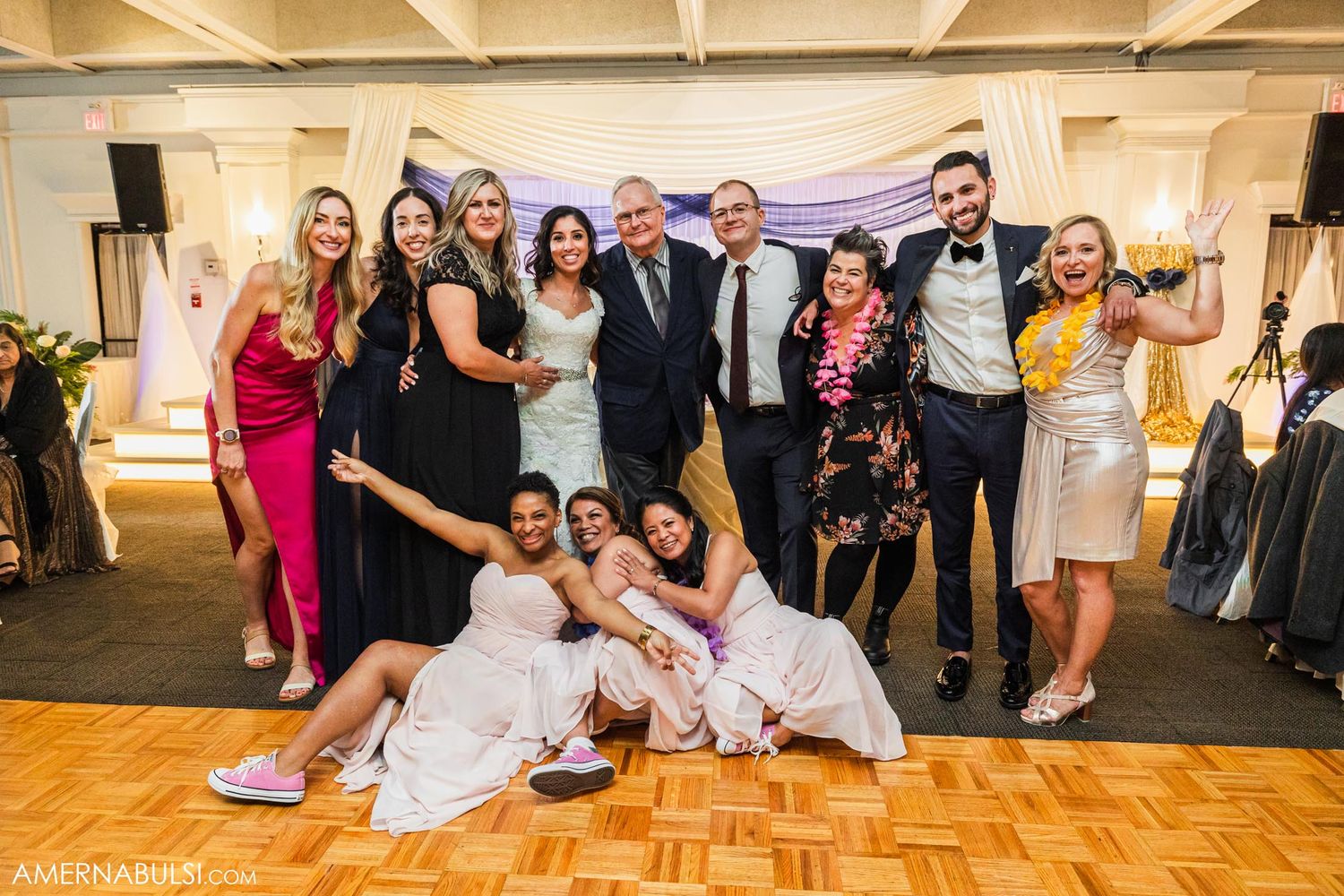 Wedding guests and party members celebrate with fun poses on the dance floor.
