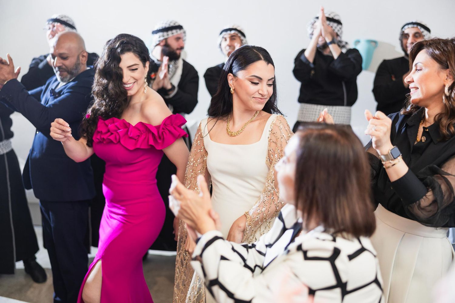 Wedding celebration with guests dancing and enjoying festivities in a modern setting.