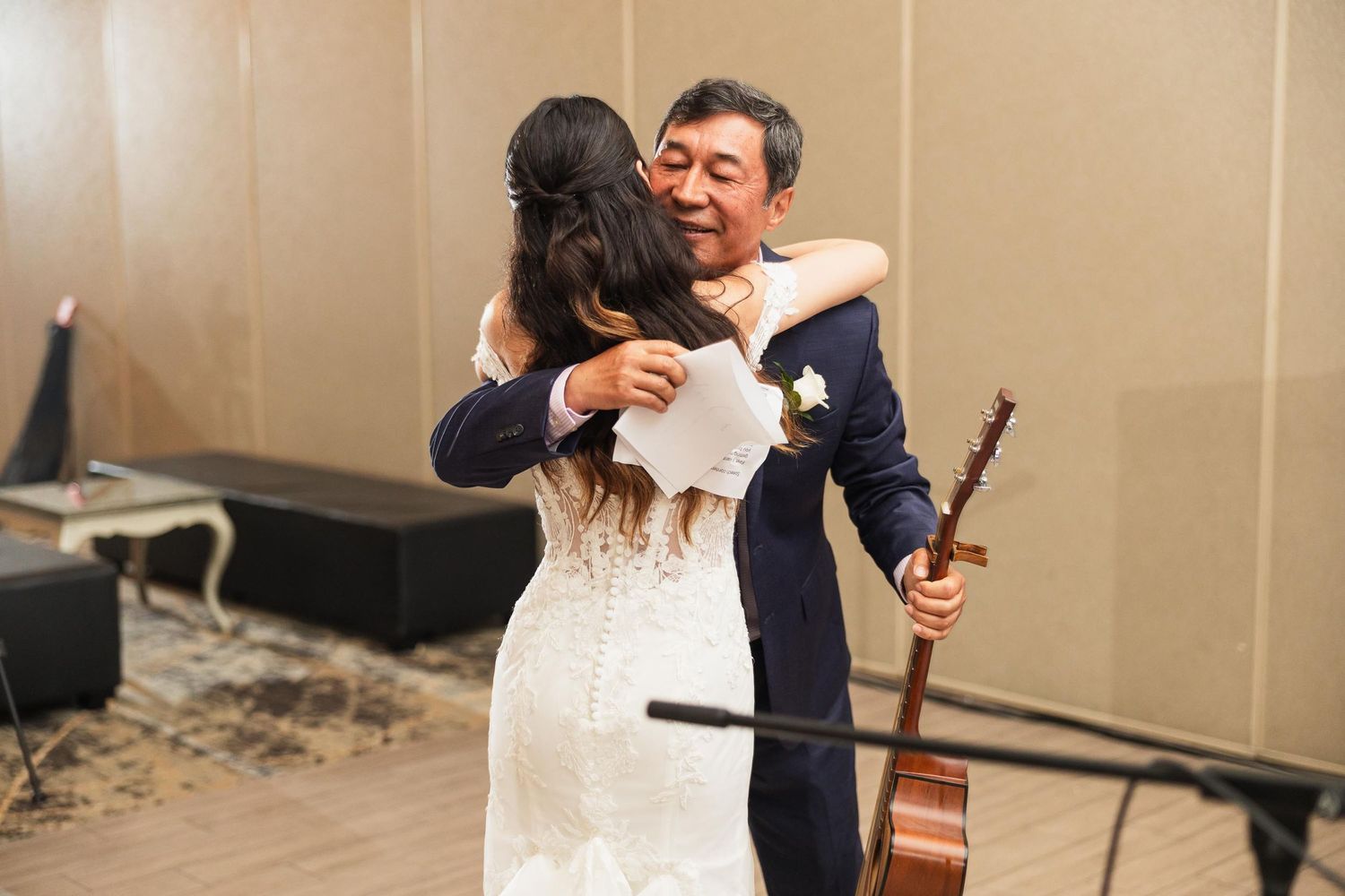 Emotional embrace during wedding reception dance.