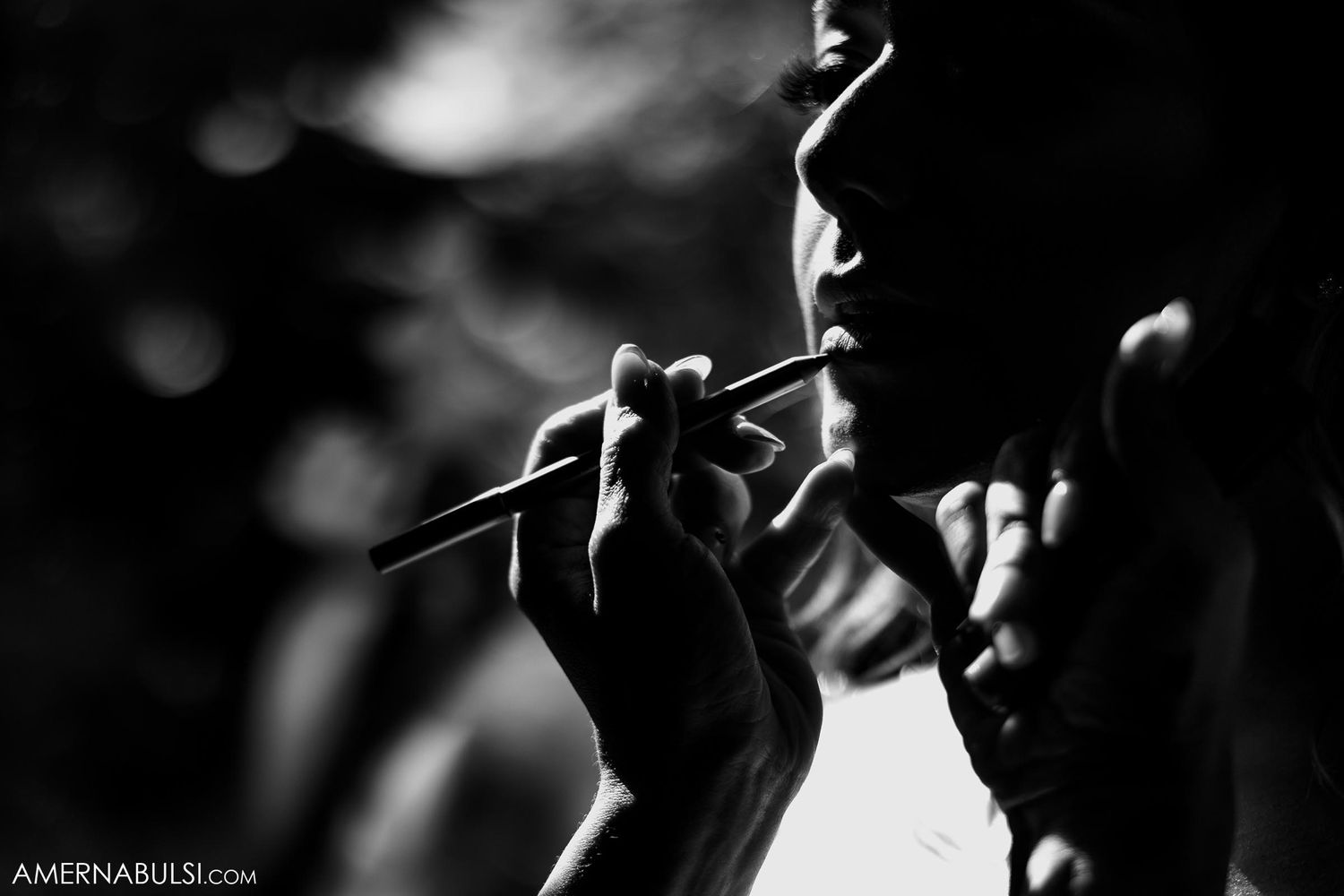 Dramatic black and white silhouette of a performer holding a microphone.