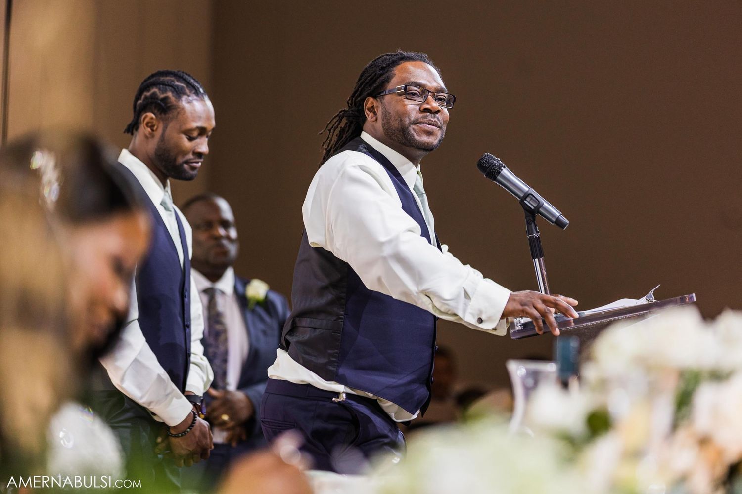 Wedding guests raise their glasses in a celebratory toast during the reception.