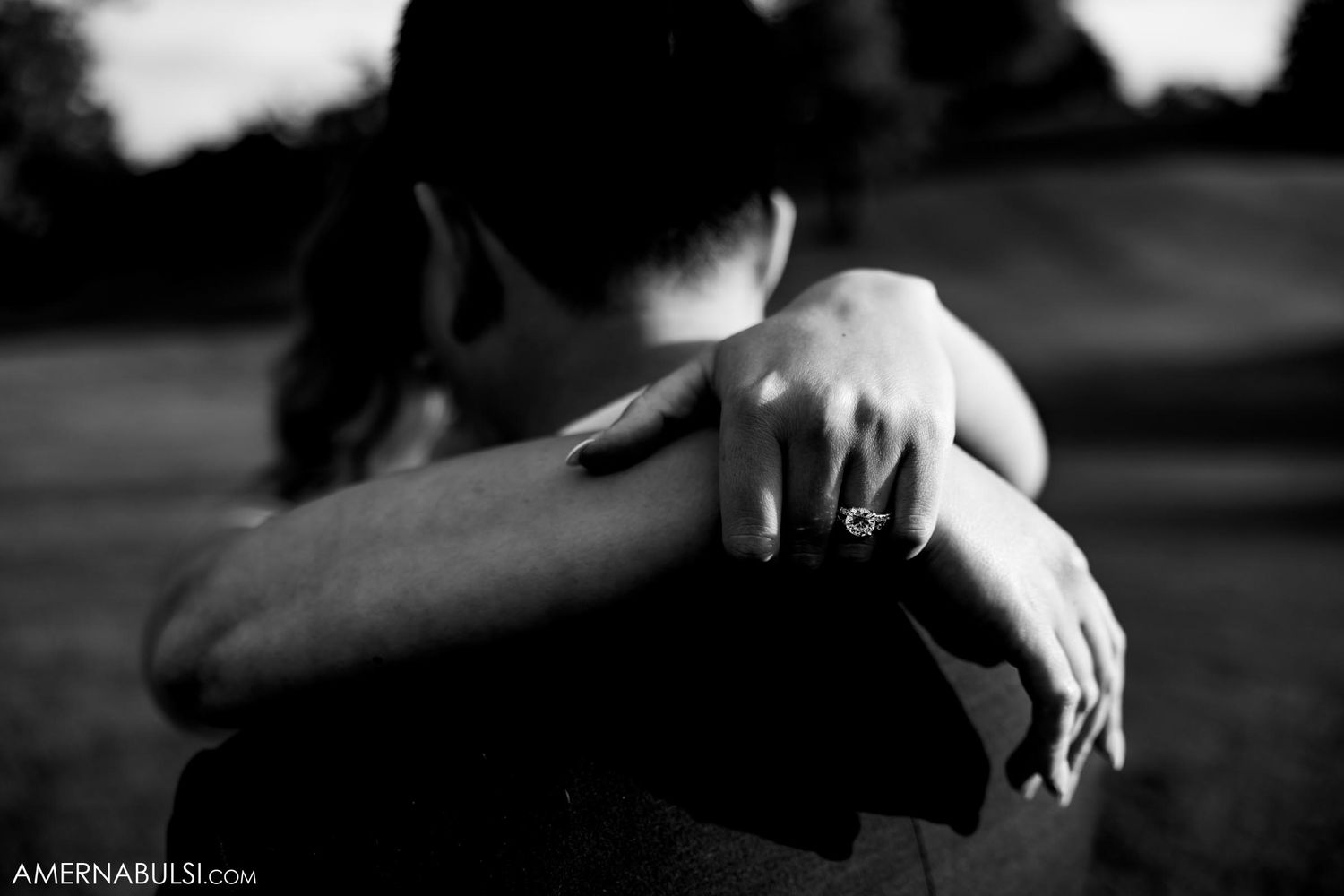 Intimate black and white photo capturing tender embrace between couple.