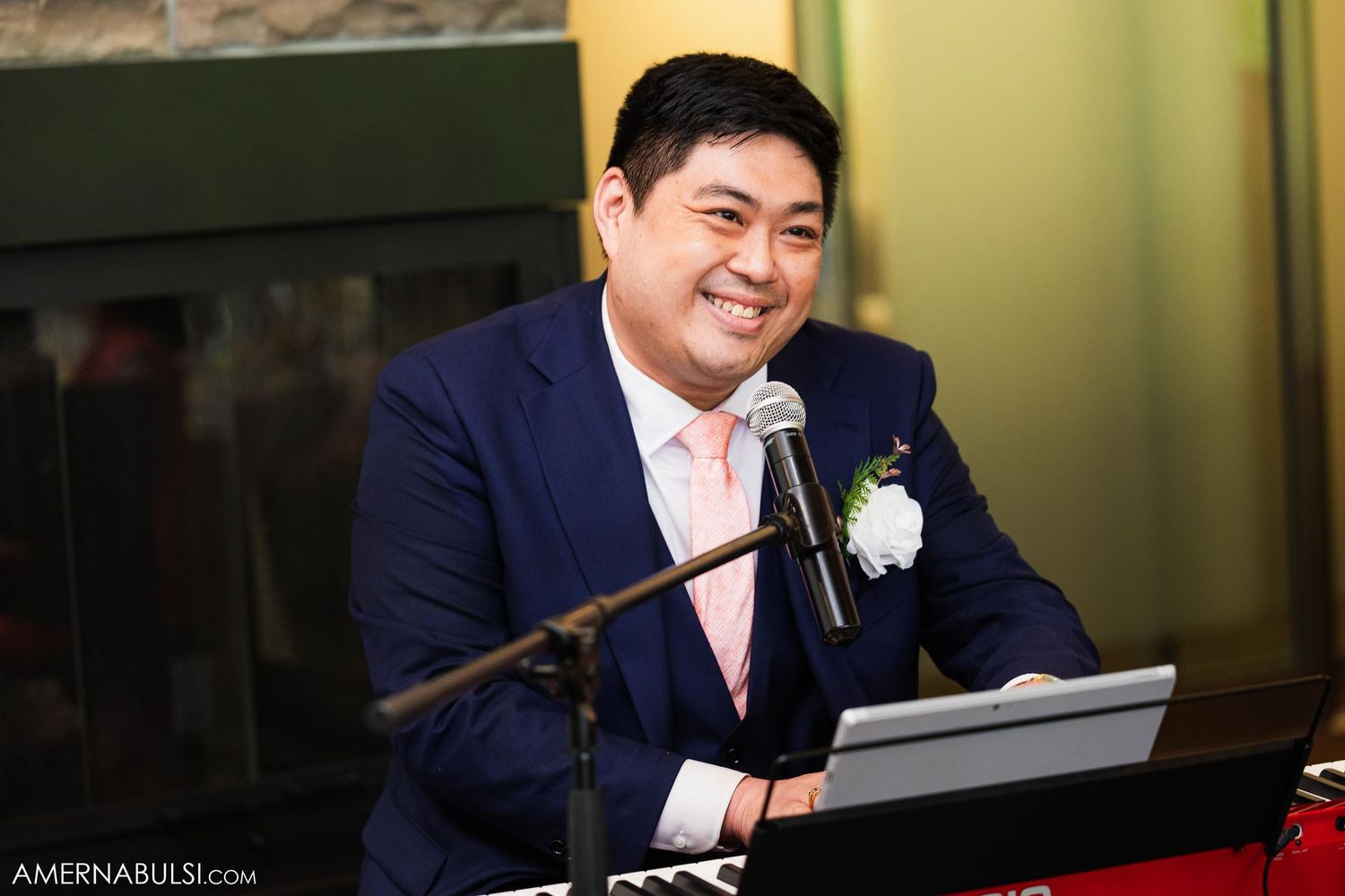 Happy speaker delivers wedding toast at formal reception venue.
