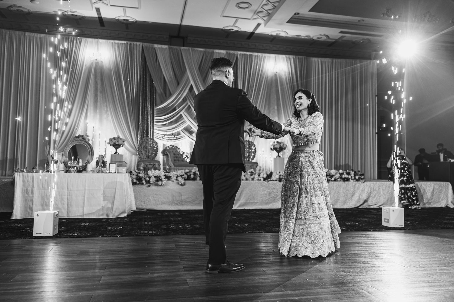 Elegant ballroom dance scene with couples gracefully moving across a grand illuminated dance floor.