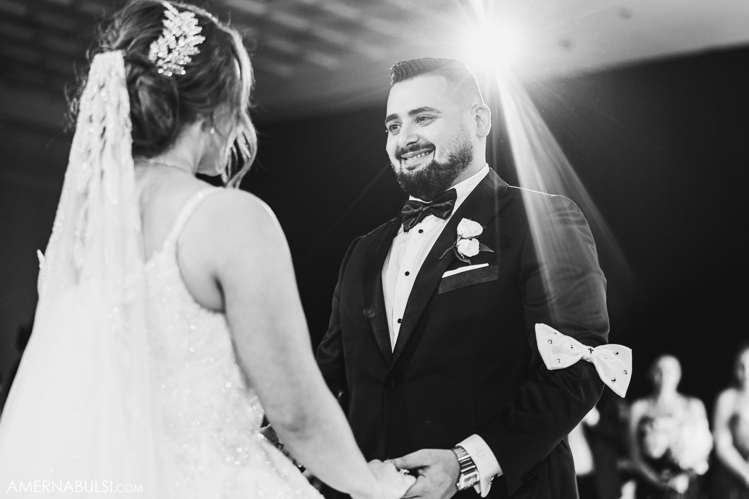 Black and white portrait of couple sharing intimate moment during wedding ceremony.