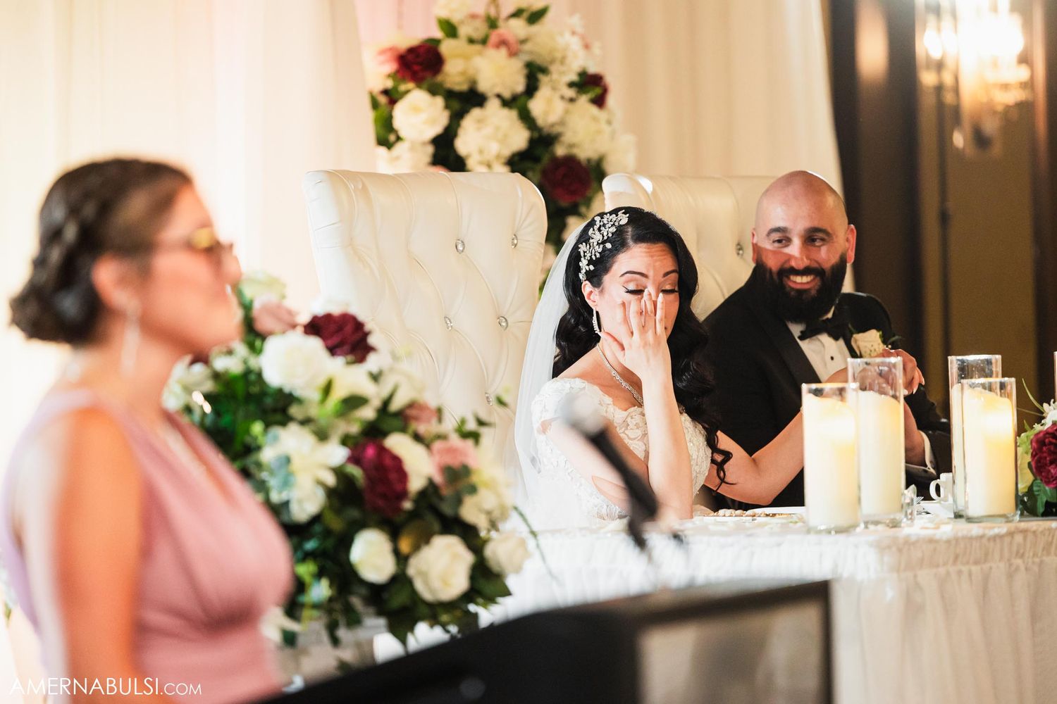 Wedding party members share emotional moments during reception speeches.