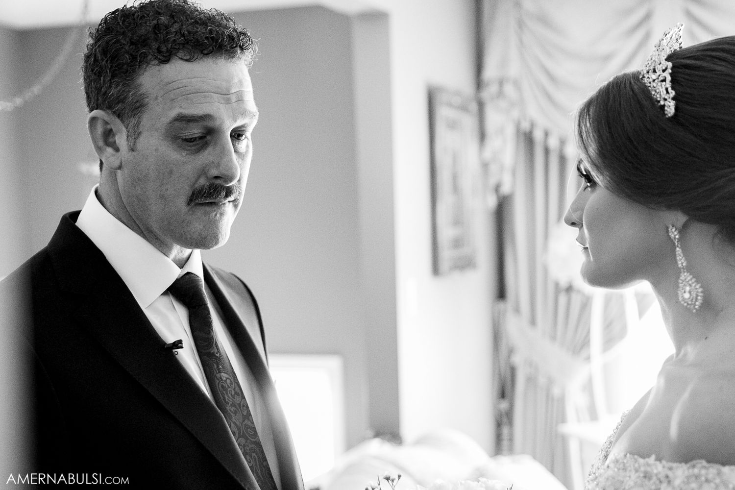 Intimate black and white portrait capturing emotional moment before wedding ceremony.