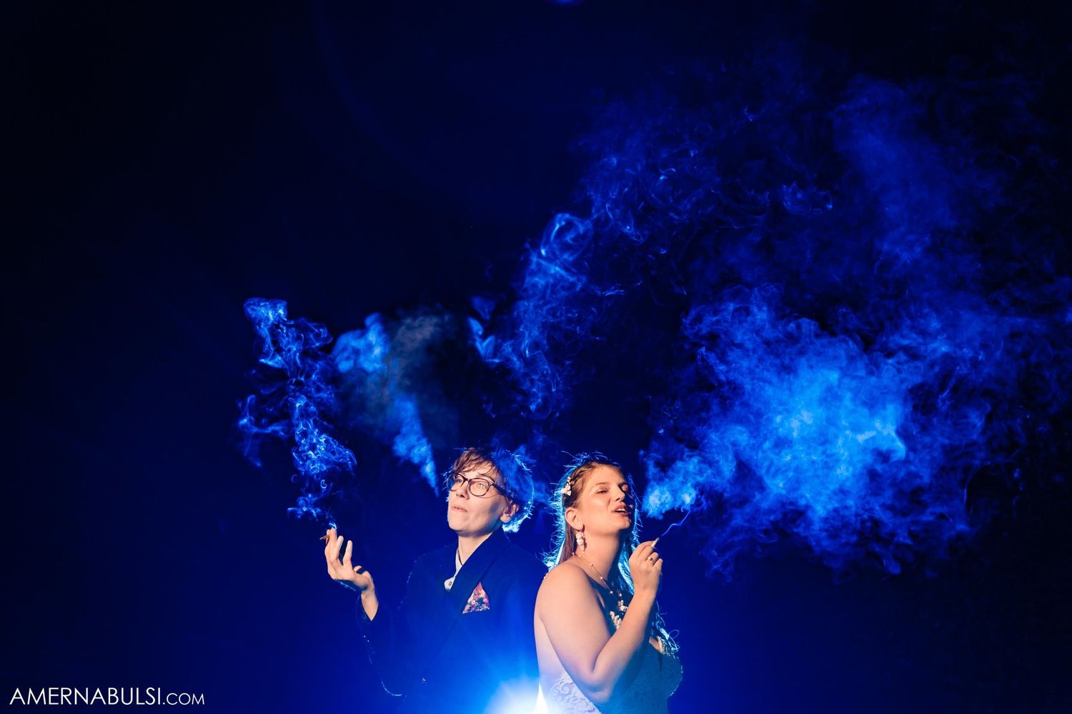 Artistic nighttime photo with dramatic blue smoke effects and backlighting creating a moody atmosphere.