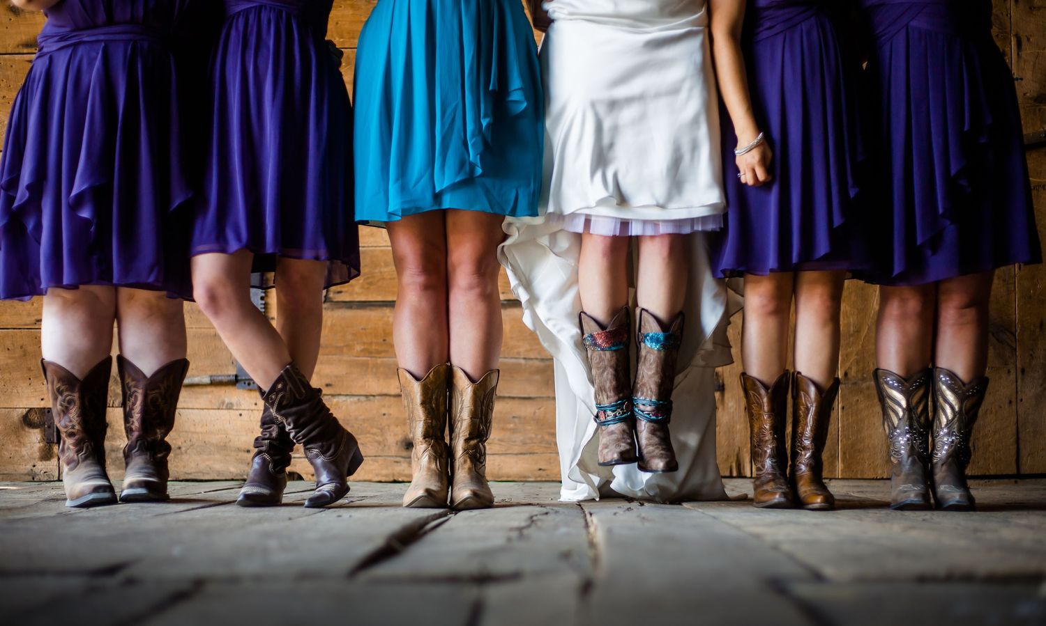 Row of wedding party members showing their shoes and dresses from knees down.
