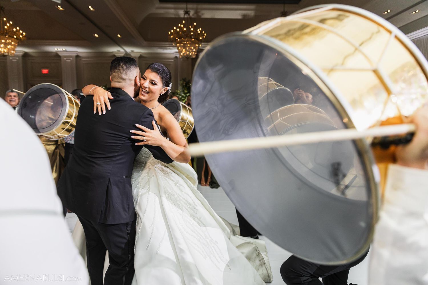 Wedding celebration featuring large drums creating atmosphere on a lively dance floor.