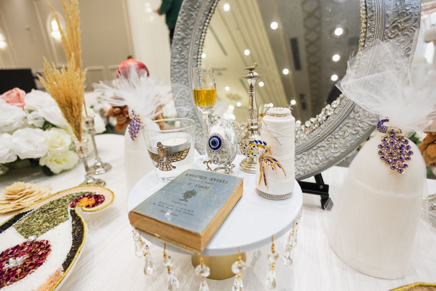 Elegant wedding reception table settings with crystal glassware and floral centerpieces.