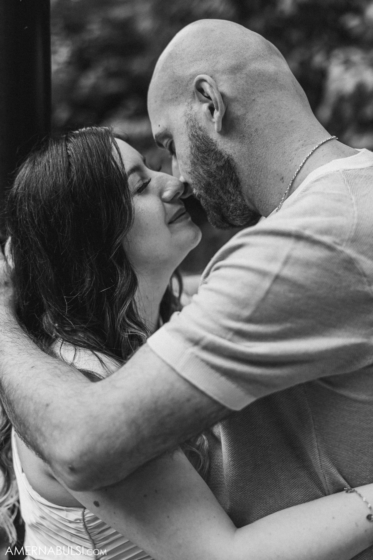 Intimate black and white close-up of couple about to kiss.