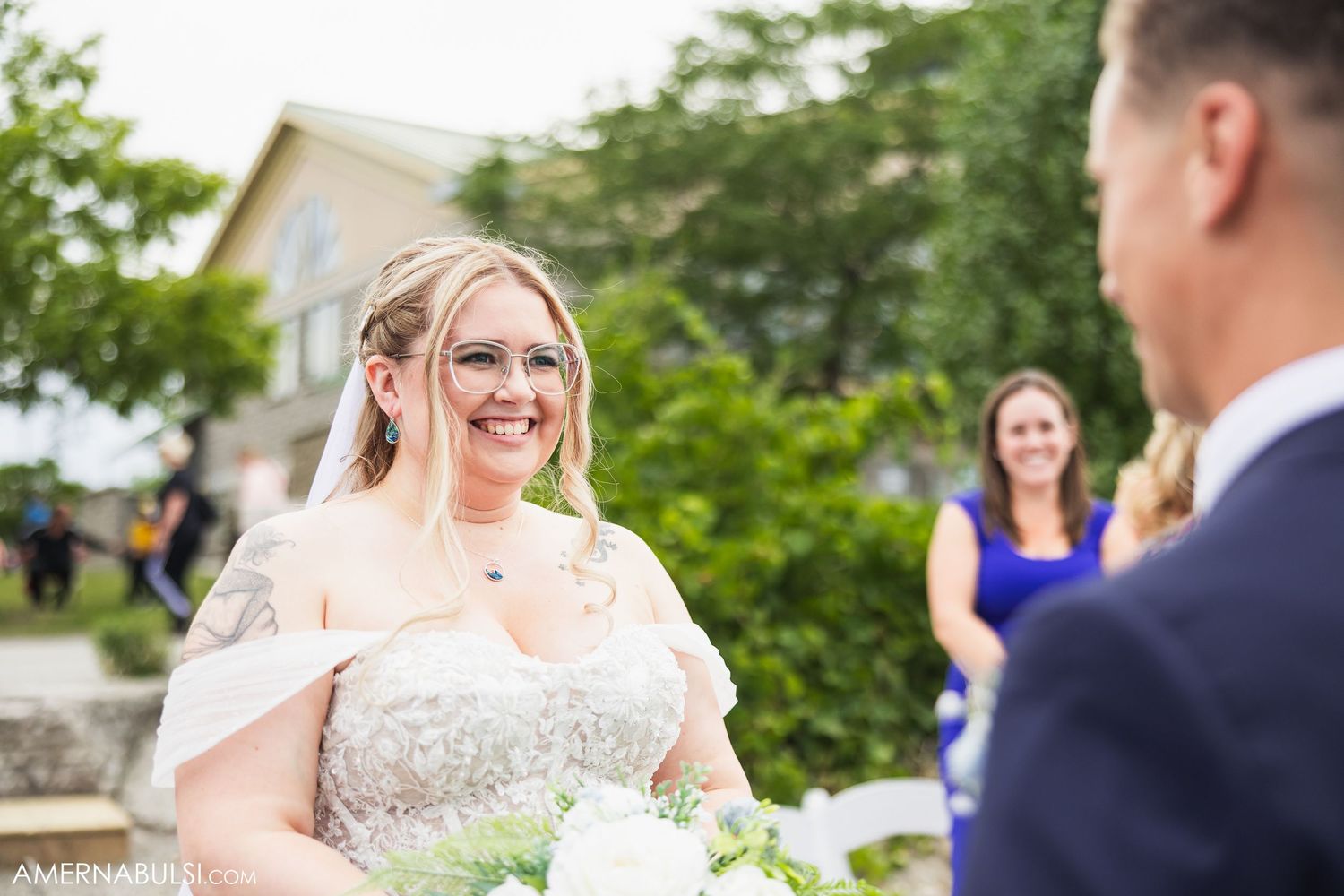 Wedding couple shares joyful moments during their outdoor garden ceremony.