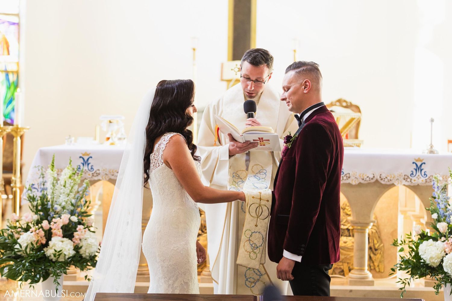 A couple exchanges vows at the altar during their traditional church wedding ceremony.
