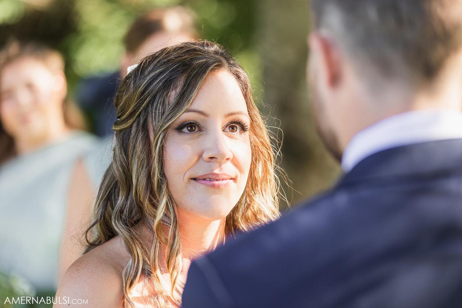 Intimate wedding ceremony moment captured in natural outdoor lighting.