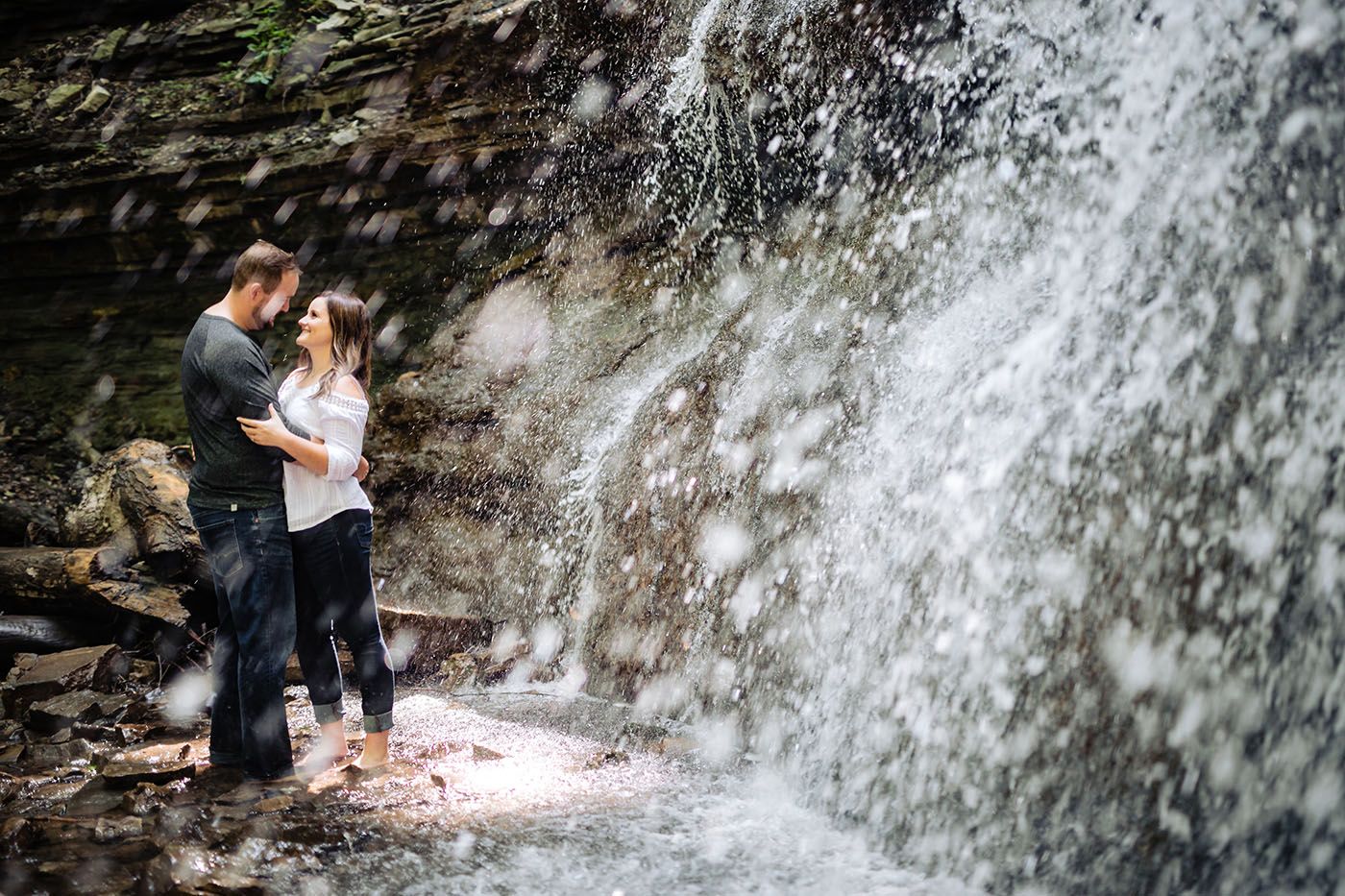 Cascading waterfall creates a romantic backdrop in the forest.