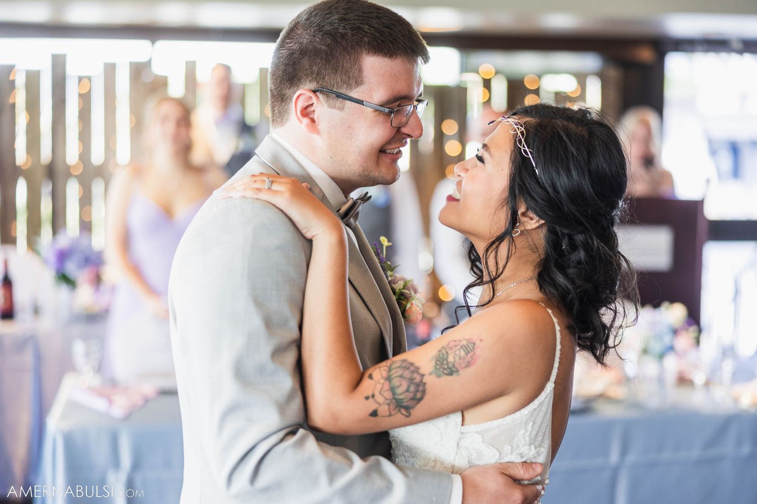 An intimate moment between a couple during their first dance at a wedding reception.