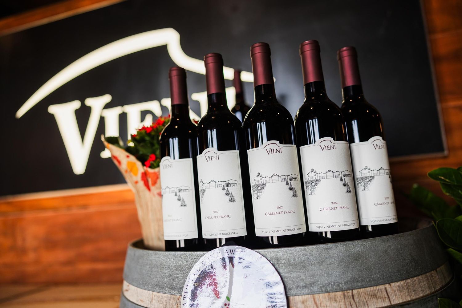 Wine bottles displayed on rustic barrel at Virtue winery.