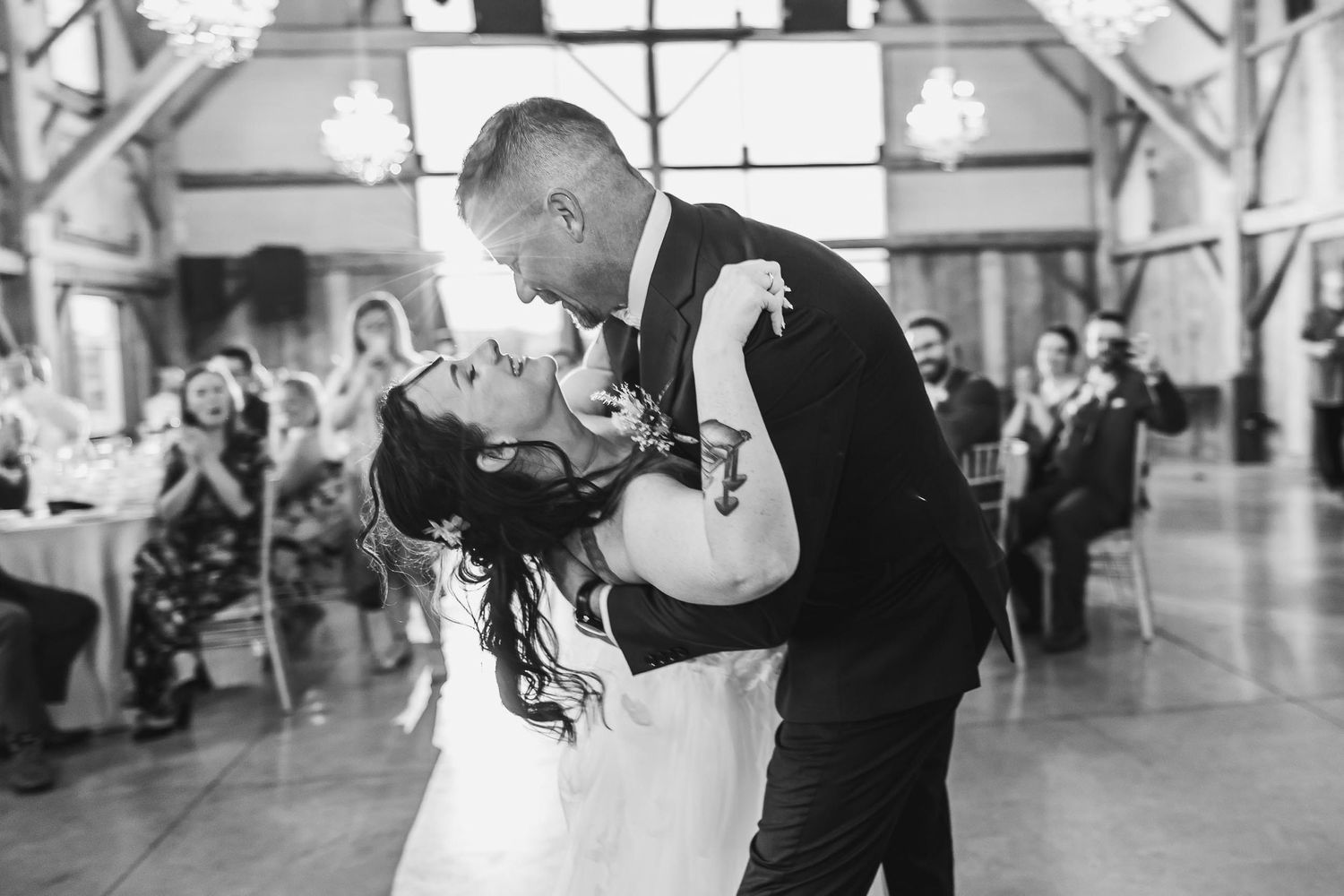 A romantic black and white dance moment during a wedding celebration.