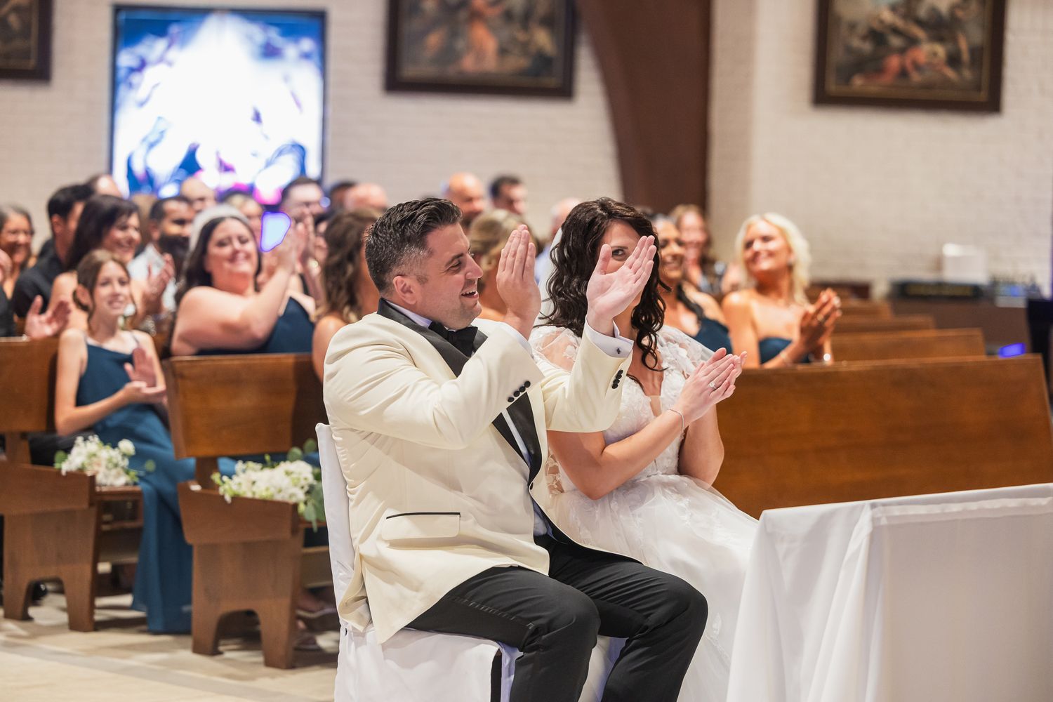Bride and groom share an emotional moment seated at the altar during their church wedding ceremony.
