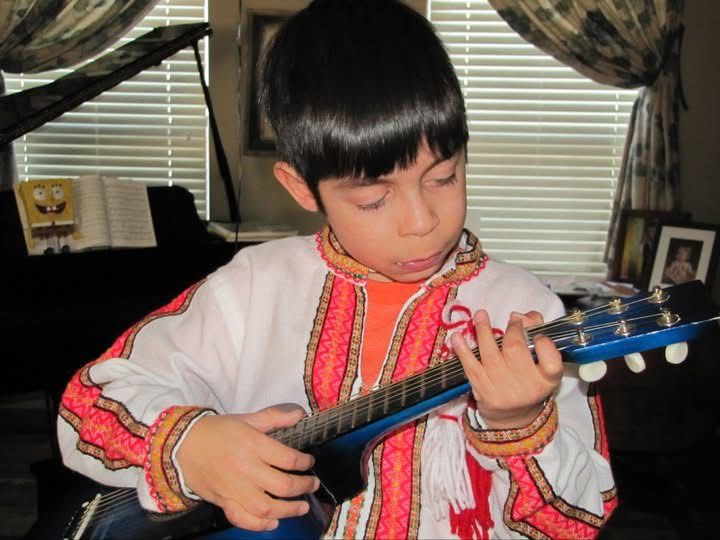 A series of photos shows someone in traditional Asian dress playing a blue guitar.