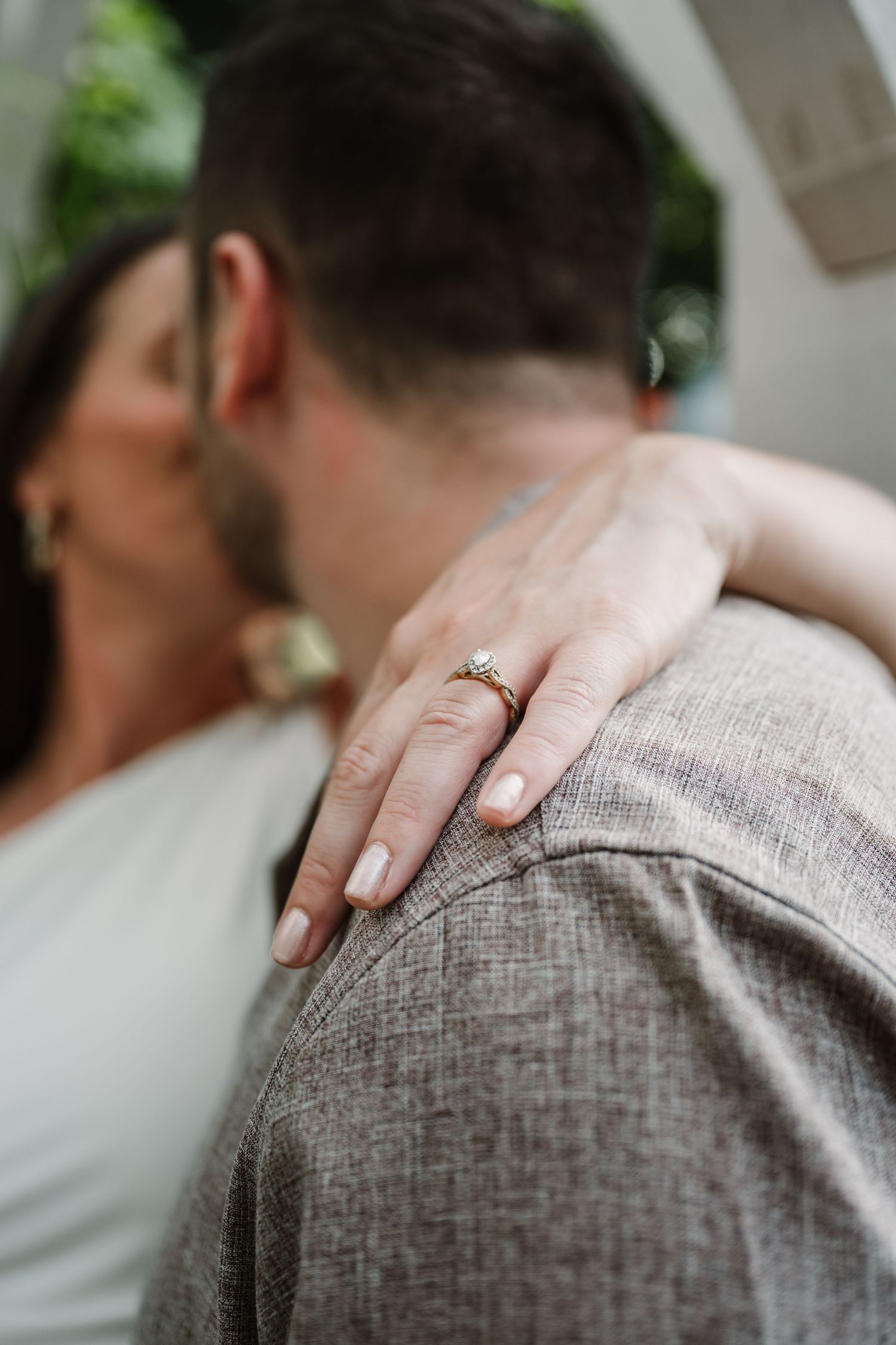Intimate close-up shot showing hands resting on textured grey fabric.
