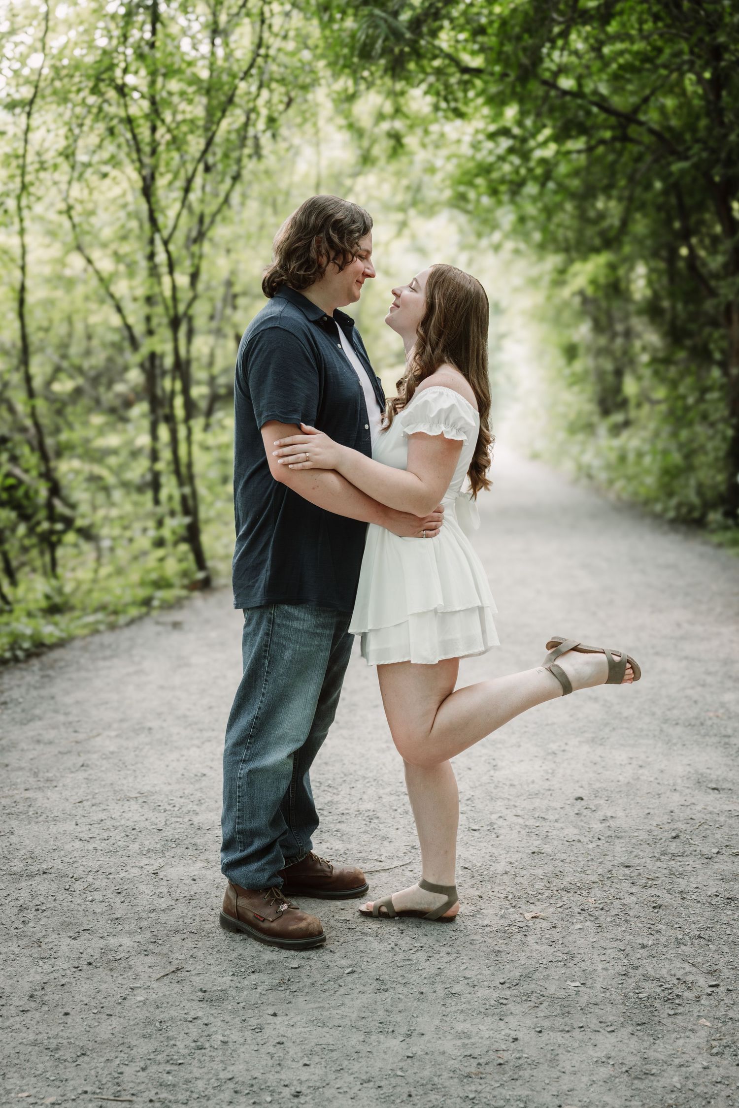 Sweet proposal moment captured on a nature trail.