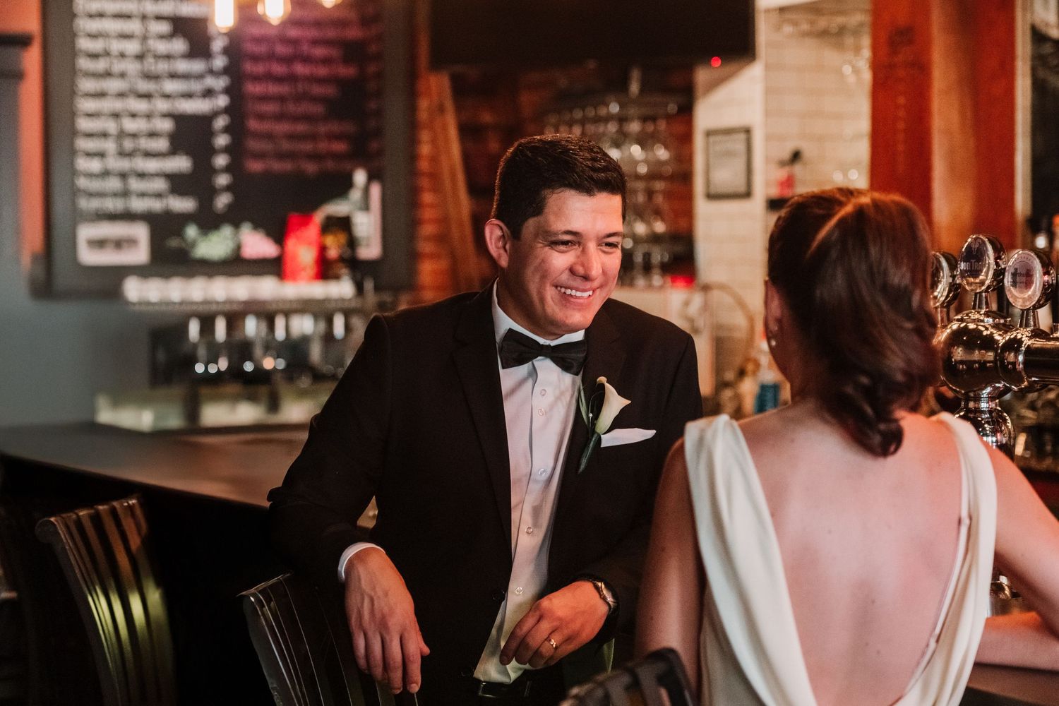 An elegant couple shares intimate moments at their wedding reception.