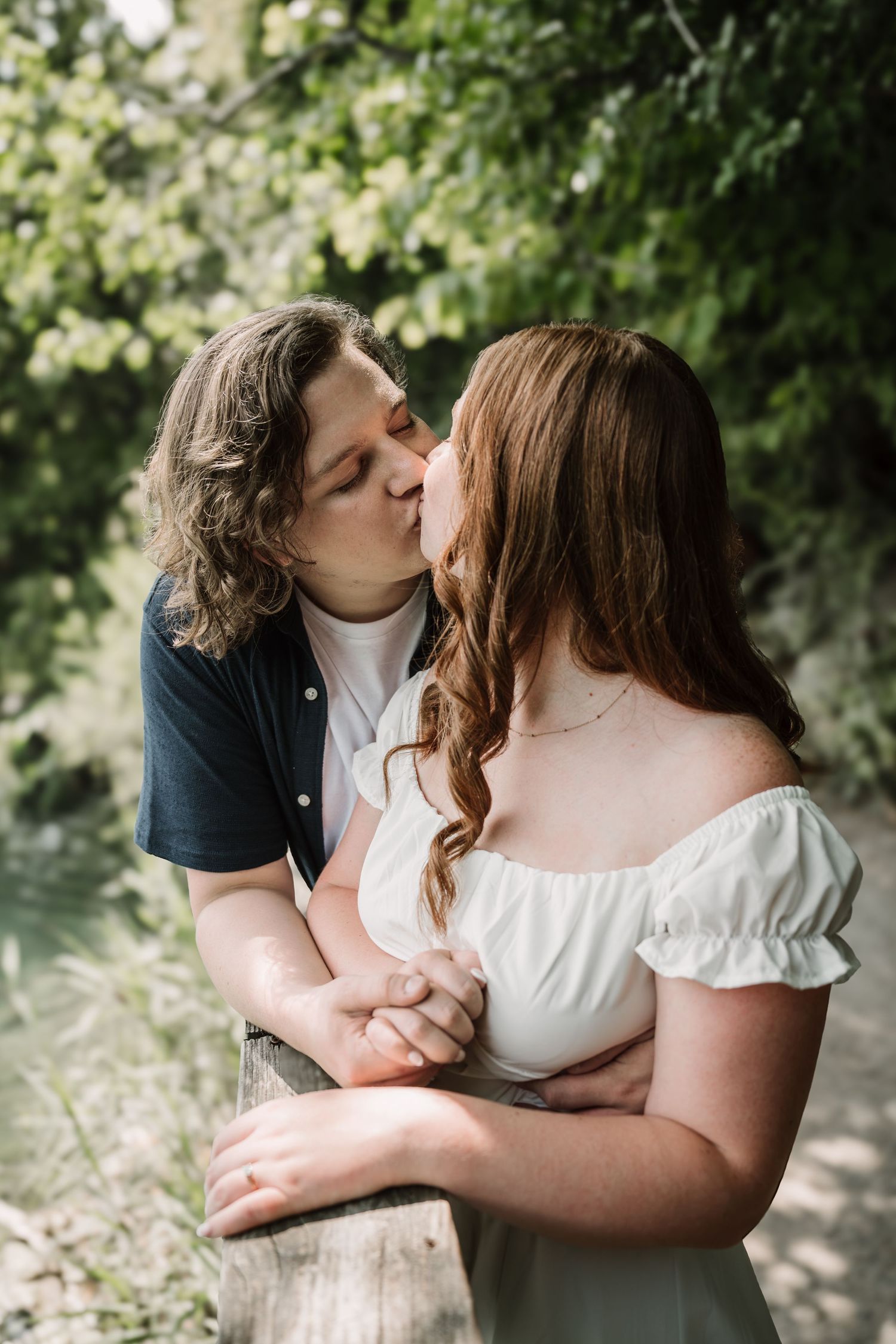 Intimate outdoor portrait session in a sunlit garden setting.