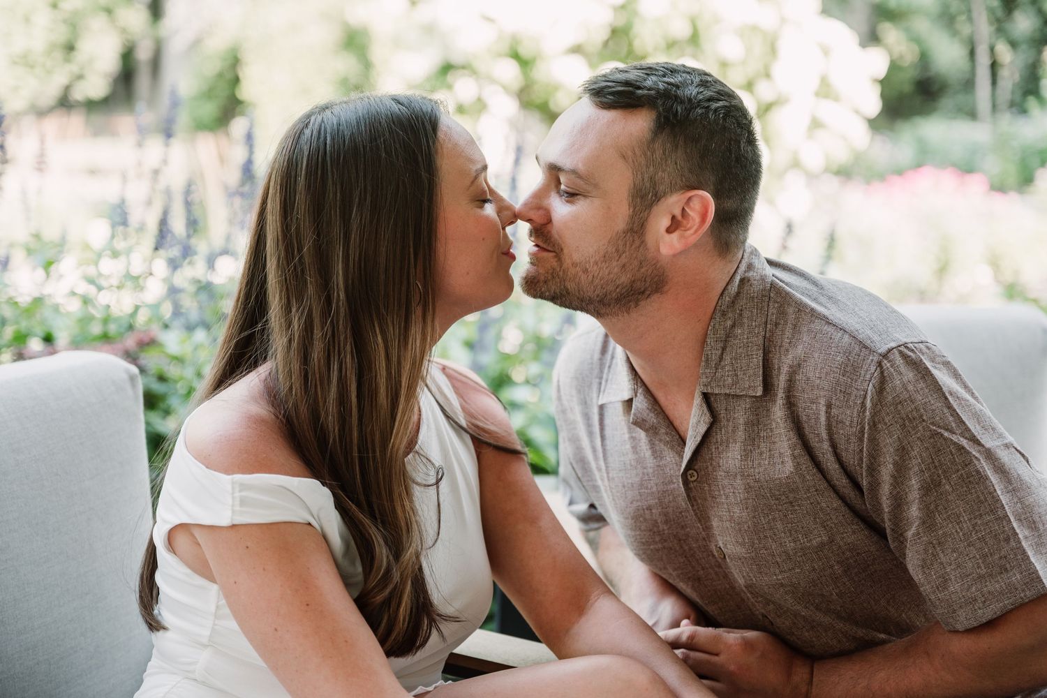 Romantic outdoor engagement photo session in a garden setting.