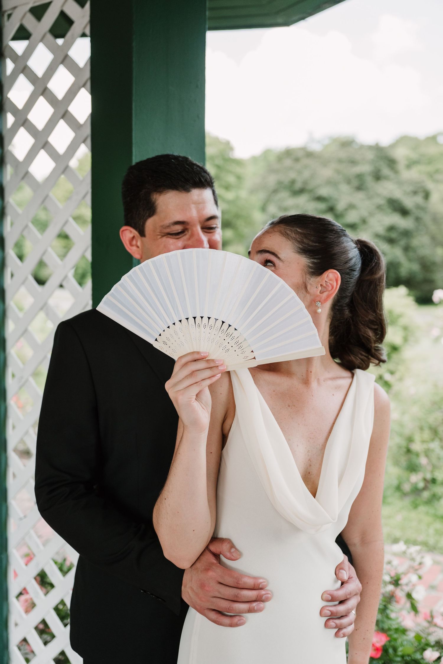 A romantic sequence with a bride holding a white fan during intimate wedding moments.